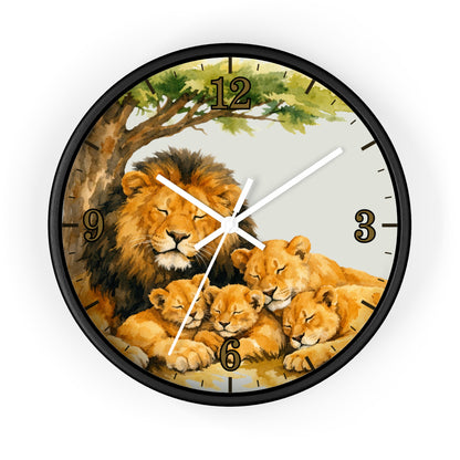 A round wall clock with a black frame and a printed illustration of a lion family under a tree. The clock face has a light gray background with black Arabic numerals and white hands.