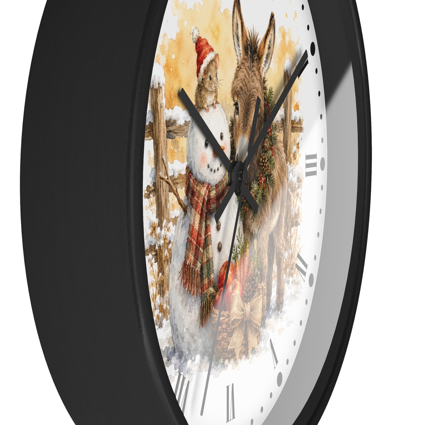 A close-up of a round wall clock with a black frame and a white face featuring a painted winter scene of a snowman and a donkey, shown against a plain white background.