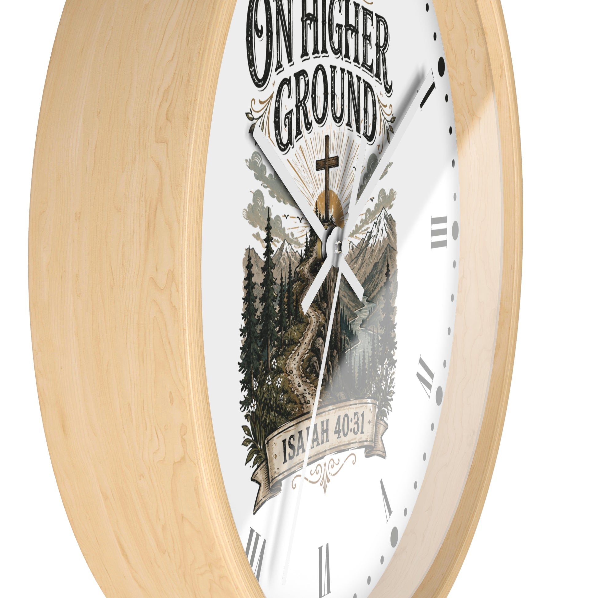 A round wall clock with a light natural wood frame and a white dial featuring a scenic mountain-and-tree illustration, the words “ON HIGHER GROUND,” and “ISAAC 40:31.”.