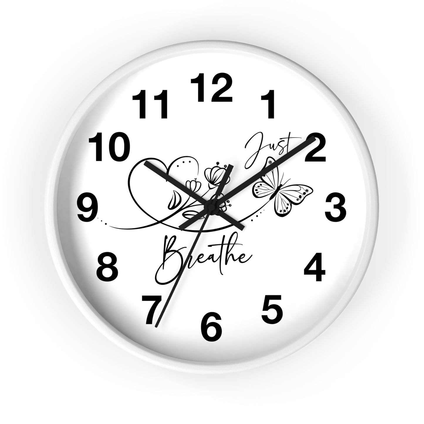 A round white wall clock with black Arabic numerals and black hands, featuring butterfly and floral illustrations with the words 'Just Breathe' on the clock face, shown against a plain white background.
