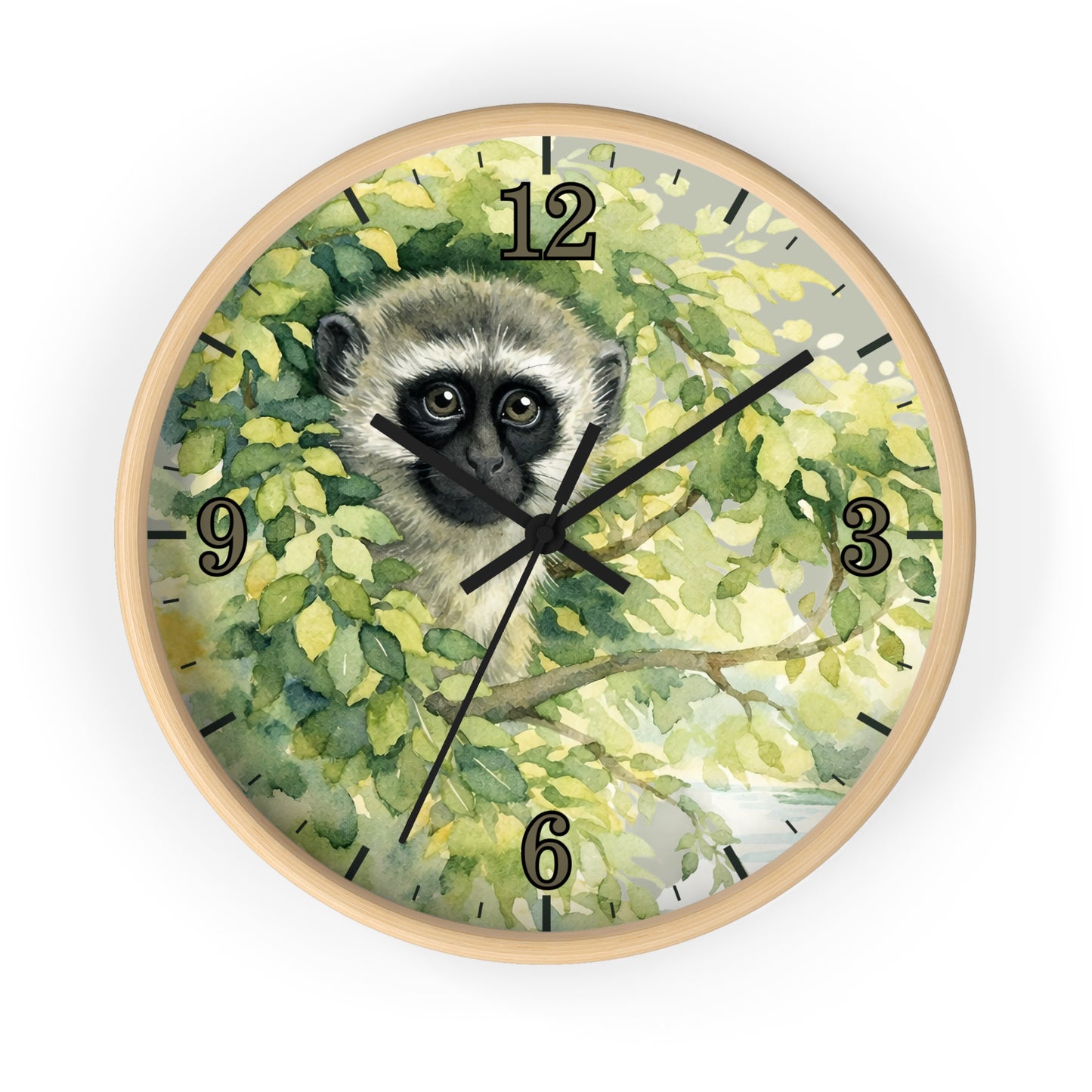 Round wall clock with a light wood frame and a printed face featuring a vervet monkey among green leaves, with black Arabic numerals and black clock hands, shown on a white background.