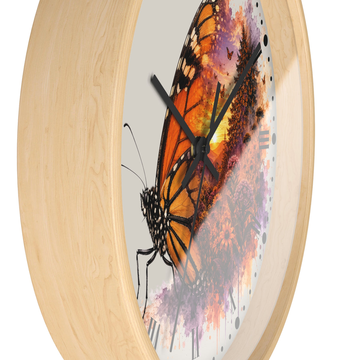 Round wall clock with a light natural wood frame and a printed butterfly artwork on the face. The design features a large orange and black butterfly over purple, pink, and orange watercolor-style floral splashes, with black clock hands and no visible numbers.