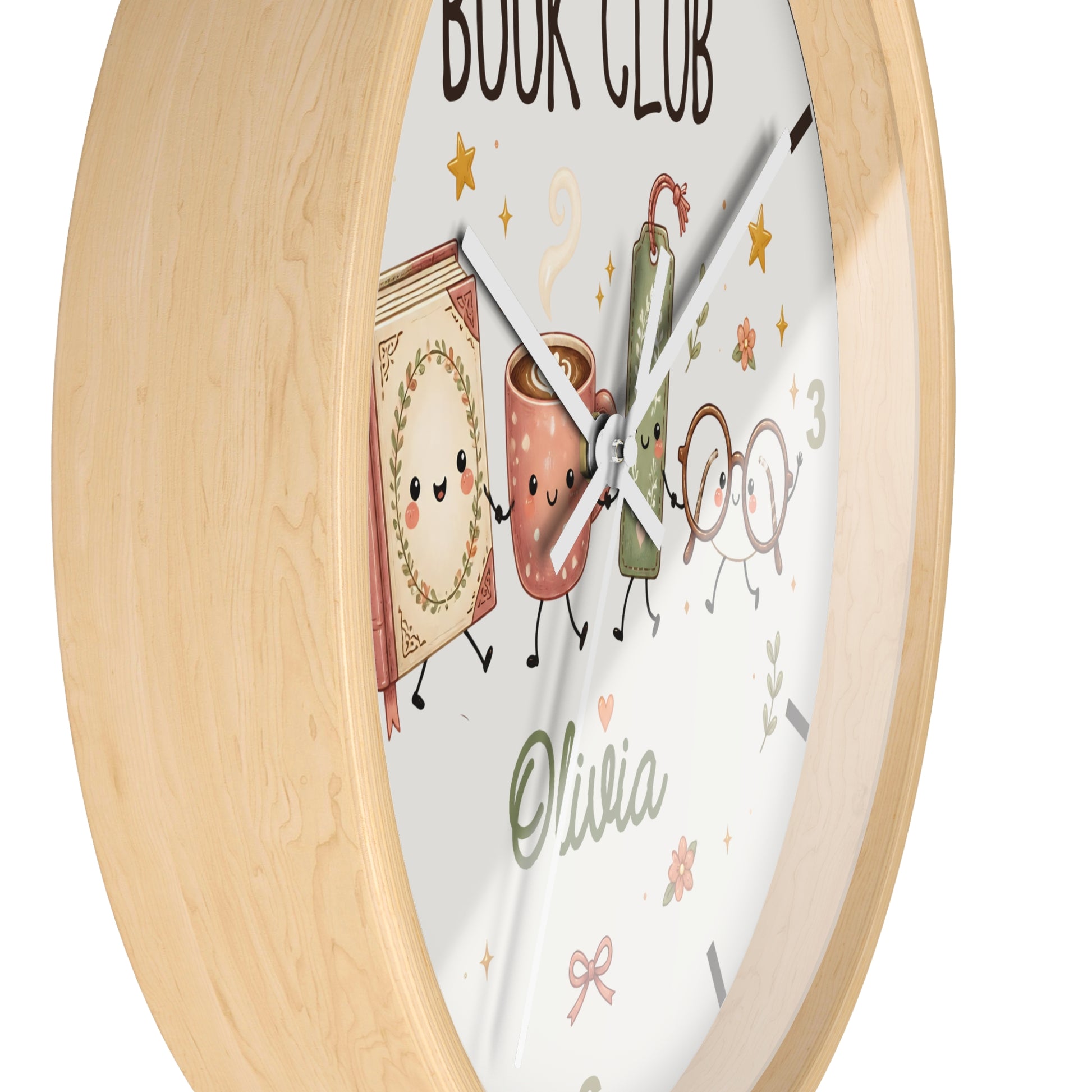 A round wall clock with a light natural wood frame and a white face featuring cute illustrated book, mug, and glasses characters, plus the text 'BOOK CLUB' and the name 'Olivia'.