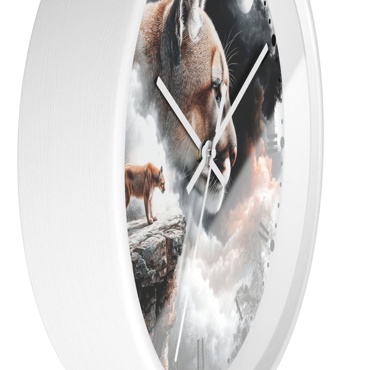 A white round wall clock with a printed scenic face showing a large cougar head, a smaller cougar standing on a rock, and dramatic clouds, photographed against a plain white background.