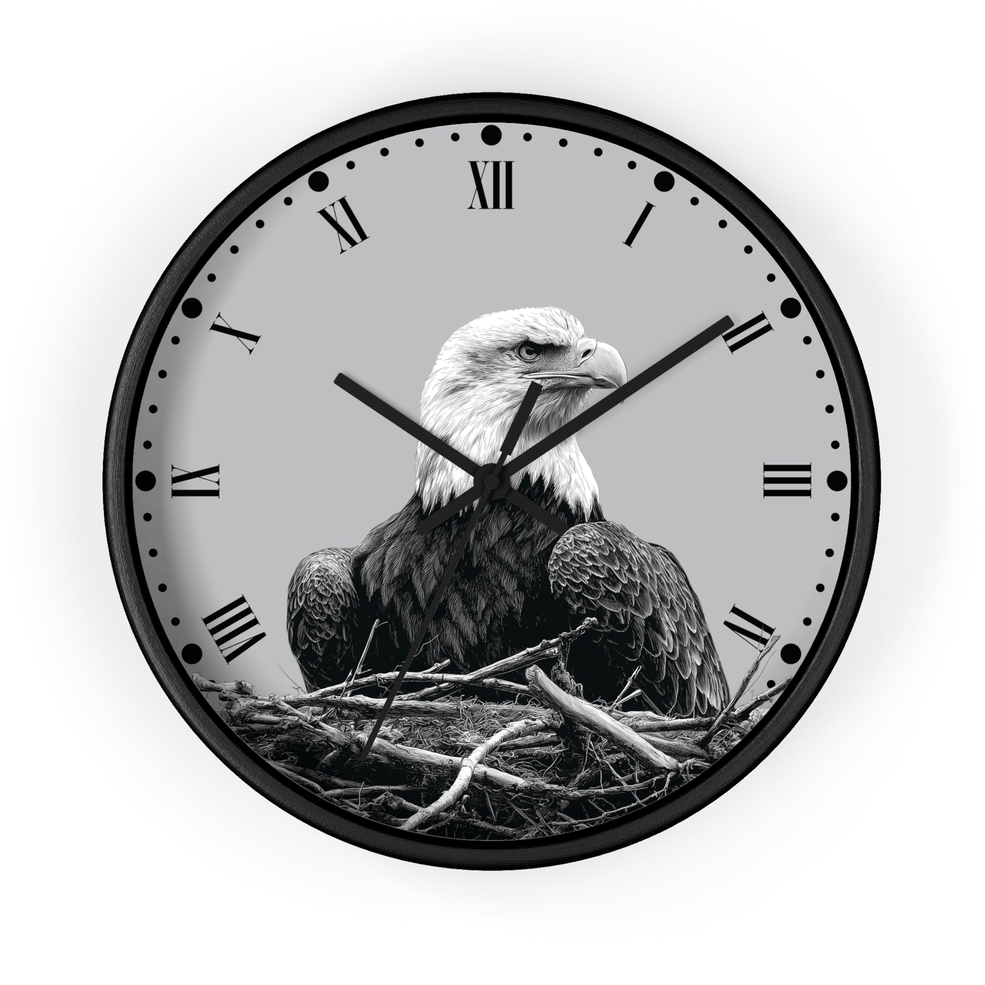 Round wall clock with a black frame and a grayscale bald eagle perched in a nest on the clock face, with Roman numerals and black hands on a light gray background.