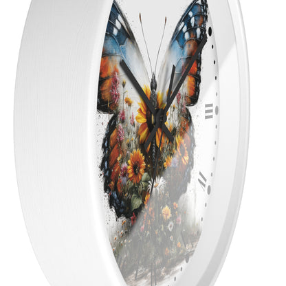 A white round wall clock with a large butterfly design printed on the face. The butterfly artwork features orange, blue, black, yellow, and brown tones with floral details, and the clock has black hands and simple black hour markers.