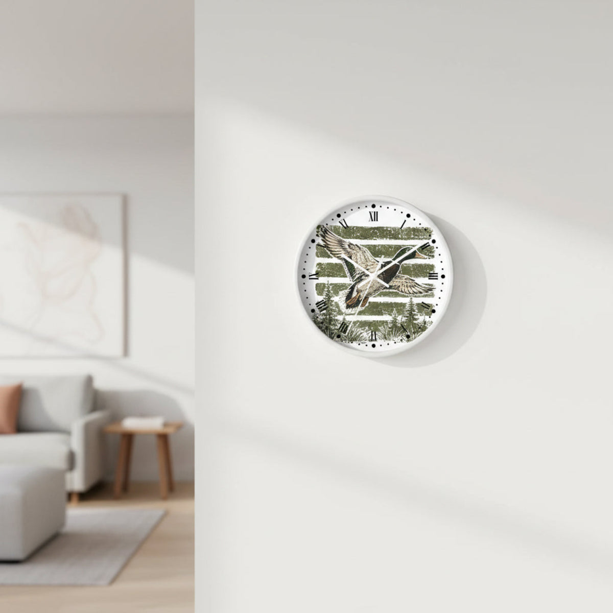 Round wall clock with a white frame and a printed duck scene on the face. The design shows a flying mallard duck over horizontal olive-green and beige stripes with pine trees along the bottom.
