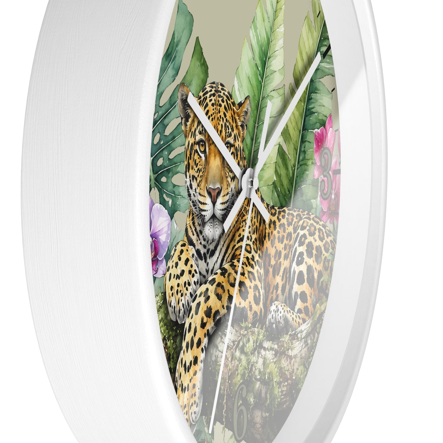 Round wall clock with a white frame and a printed tropical jungle scene featuring a leopard, green leaves, and pink flowers on the face.