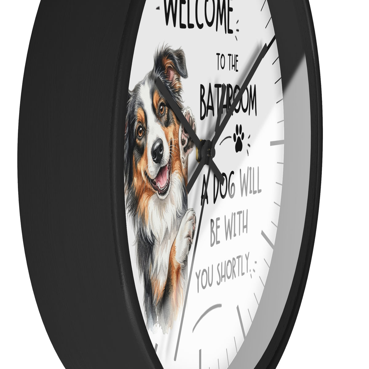 A round wall clock with a black frame and a white face featuring a painted dog portrait and the text 'WELCOME TO THE BATROOM A DOG WILL BE WITH YOU SHORTLY'.