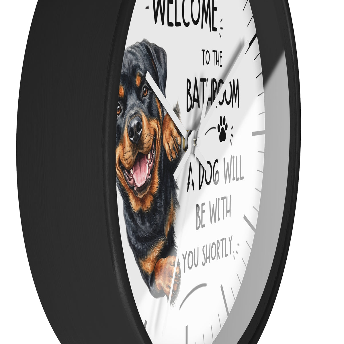 A round wall clock with a black frame and a white face featuring a Rottweiler dog illustration and the text 'WELCOME TO THE BATHROOM A DOG WILL BE WITH YOU SHORTLY'.