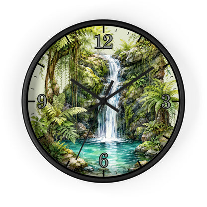 A round wall clock with a black frame and a printed scenic dial showing a lush tropical waterfall, green foliage, rocks, and a turquoise pool. Black Arabic numerals mark the hours, and the clock hands are black.