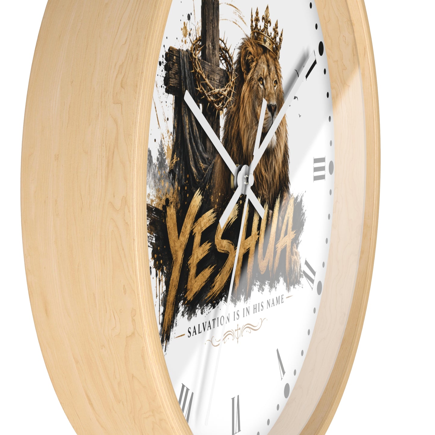 A round wall clock with a light natural wood frame and a white face featuring a crowned lion, a cross, gold splatter-style lettering reading 'YESHUA', and the phrase 'SALVATION IS IN HIS NAME'.