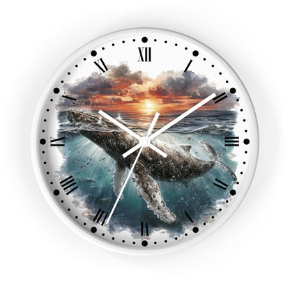 Round wall clock with a white frame and face, featuring a printed illustration of a humpback whale swimming in ocean water at sunset. The clock has black Roman numerals, black dot hour markers, and white hands.