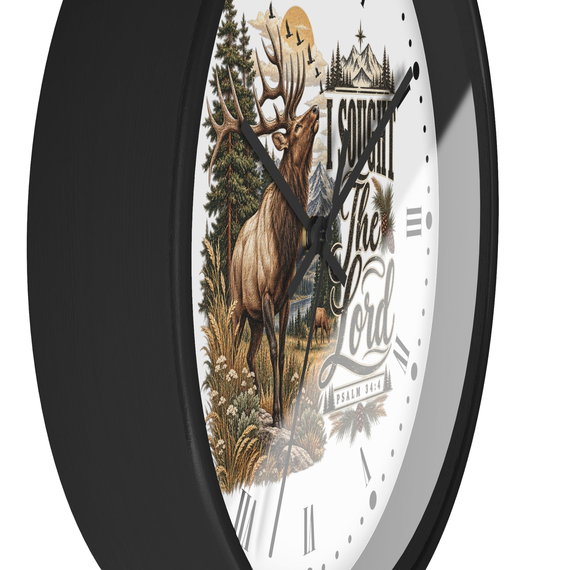 A round wall clock with a black frame and a white face featuring a detailed illustration of a deer in a forest, a castle, and the text 'I Sought The Lord' 