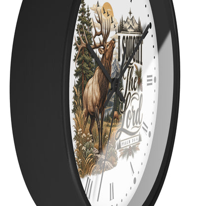A round wall clock with a black frame and a white face featuring a detailed illustration of a deer in a forest, a castle, and the text 'I Sought The Lord' 