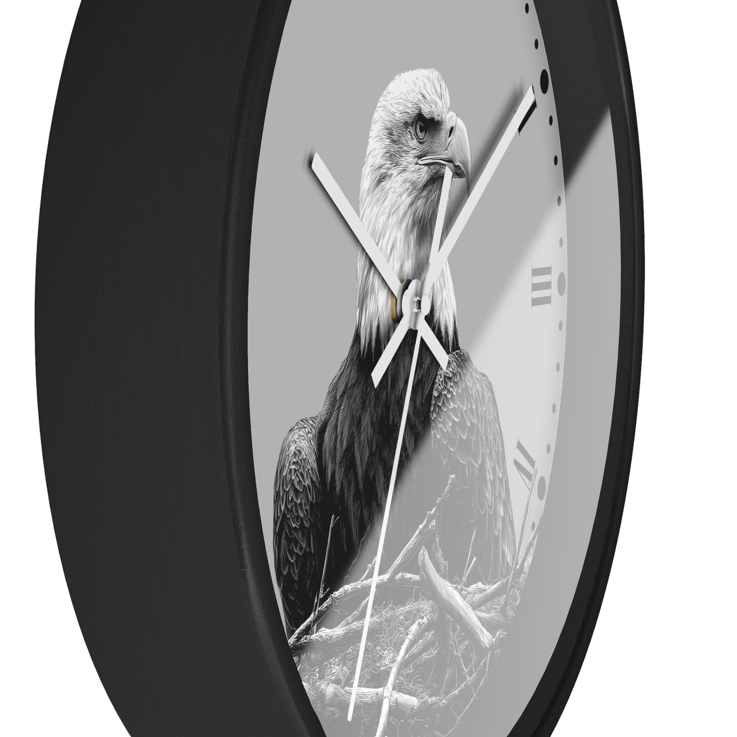 A round wall clock with a black frame and a monochrome photograph of a bald eagle on the face, with white clock hands and Roman numeral hour markers.