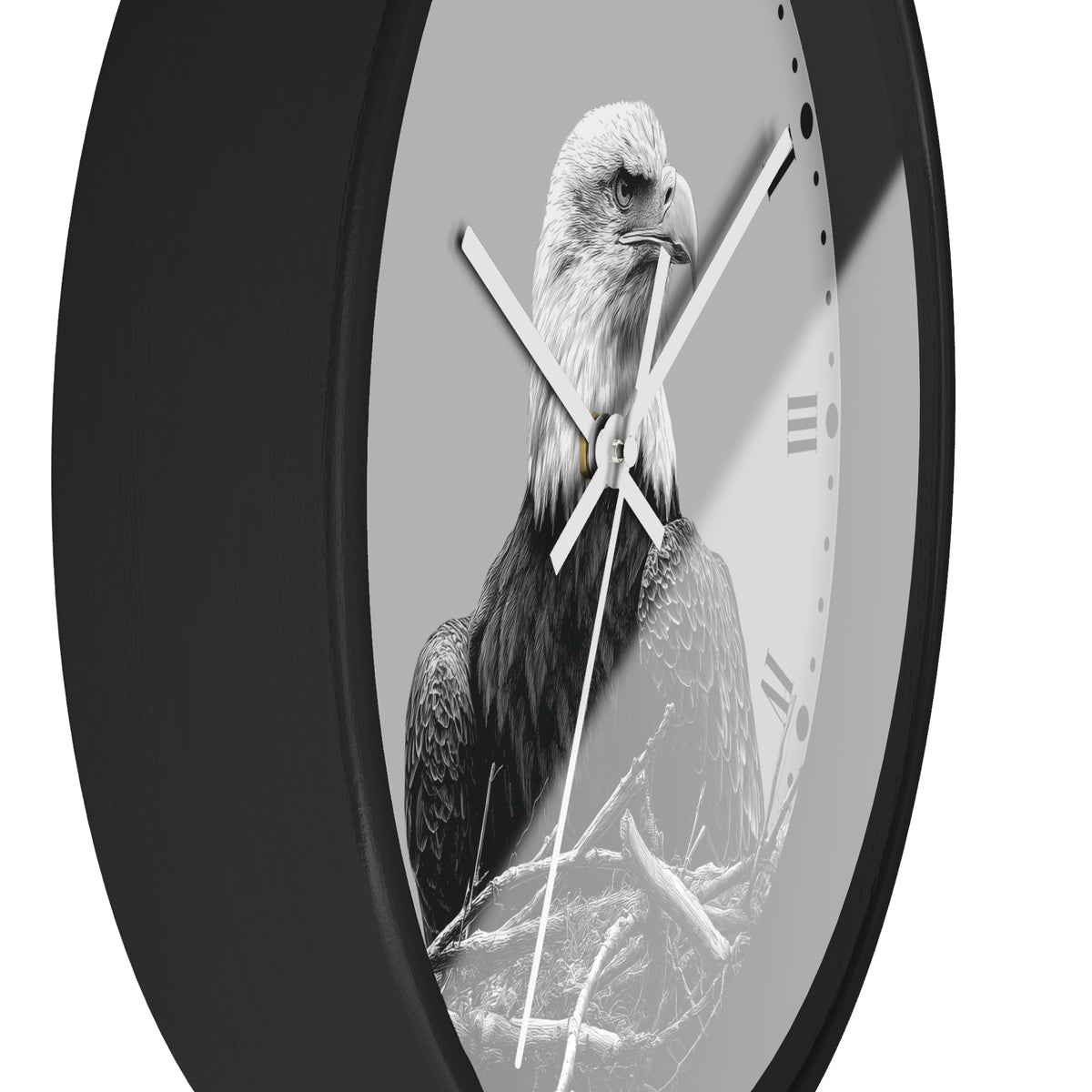 A round wall clock with a black frame and a monochrome photograph of a bald eagle on the face, with white clock hands and Roman numeral hour markers.