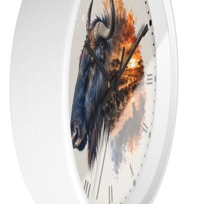 A round wall clock with a white frame and a printed dial featuring a detailed blue wildebeest head over an orange sunset landscape, shown against a plain white background.