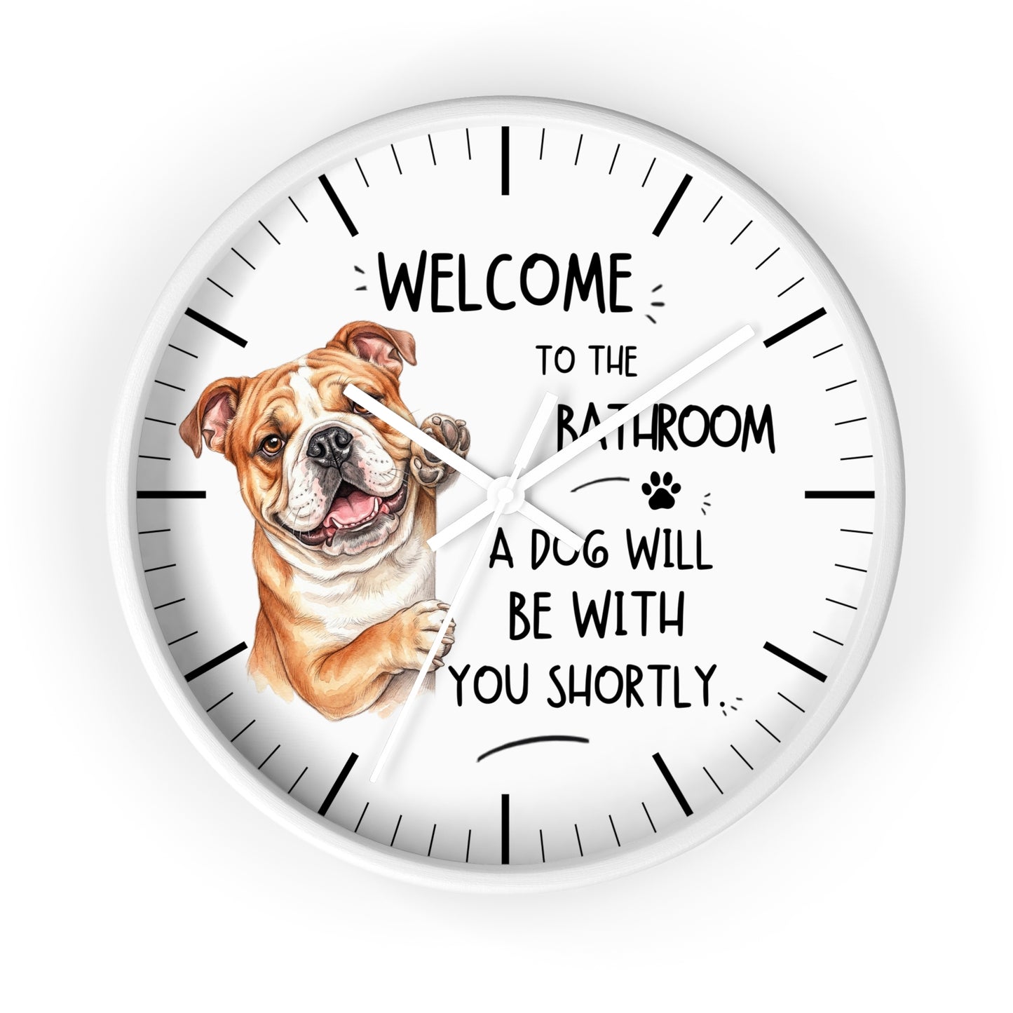 A round white wall clock with black hands and hour markers, featuring a brown and white bulldog illustration on the left and the text 'WELCOME TO THE BATHROOM A DOG WILL BE WITH YOU SHORTLY.' on a white background.