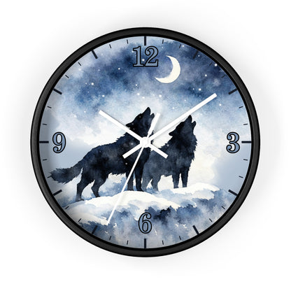 A round wall clock with a black frame and a printed night sky face showing two black howling wolves, a crescent moon, stars, and blue watercolor-style scenery. The numbers 1 through 12 are visible around the dial.
