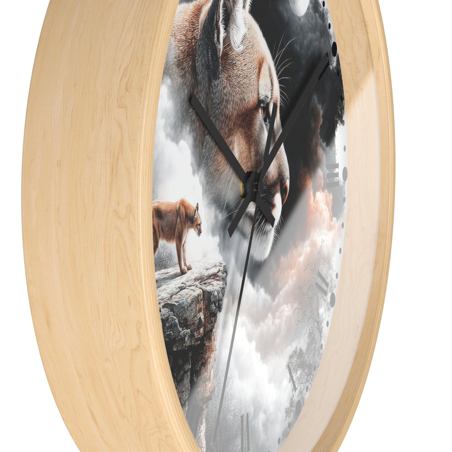 A round wall clock with a light natural wood frame and a printed scenic face showing a large cougar head, a smaller cougar standing on a rock, and cloudy white and gray sky. The clock is shown at an angle against a plain white background.