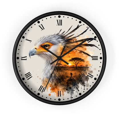 A round wall clock with a black frame and Roman numerals, featuring a detailed painting of an eagle's head on the left side and an orange sunset landscape with a tree on the right side, set against a plain white background.
