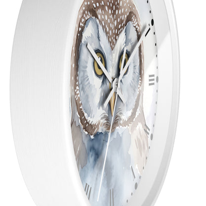 A white round wall clock featuring a detailed watercolor illustration of an owl face on the dial, with white hands and black Roman numerals.