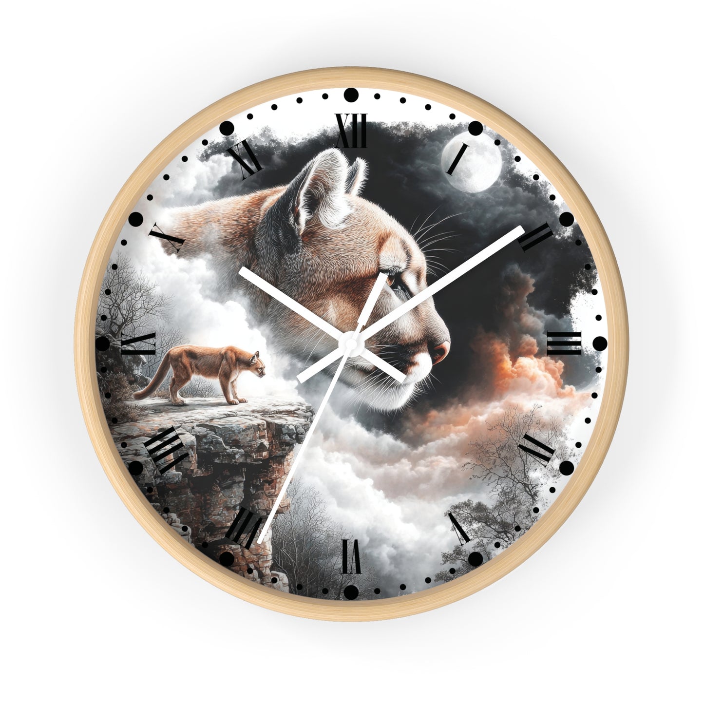 A round wall clock with a light wood frame, featuring a surreal printed design of a large cat head over a mountain landscape with a smaller cat standing on a cliff. The clock face has black Roman numerals, white hands, and a light gray background around the product.