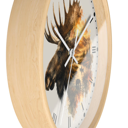 Round wall clock with a light natural wood frame and a printed moose head over an autumn forest scene on the dial, shown against a plain white background.