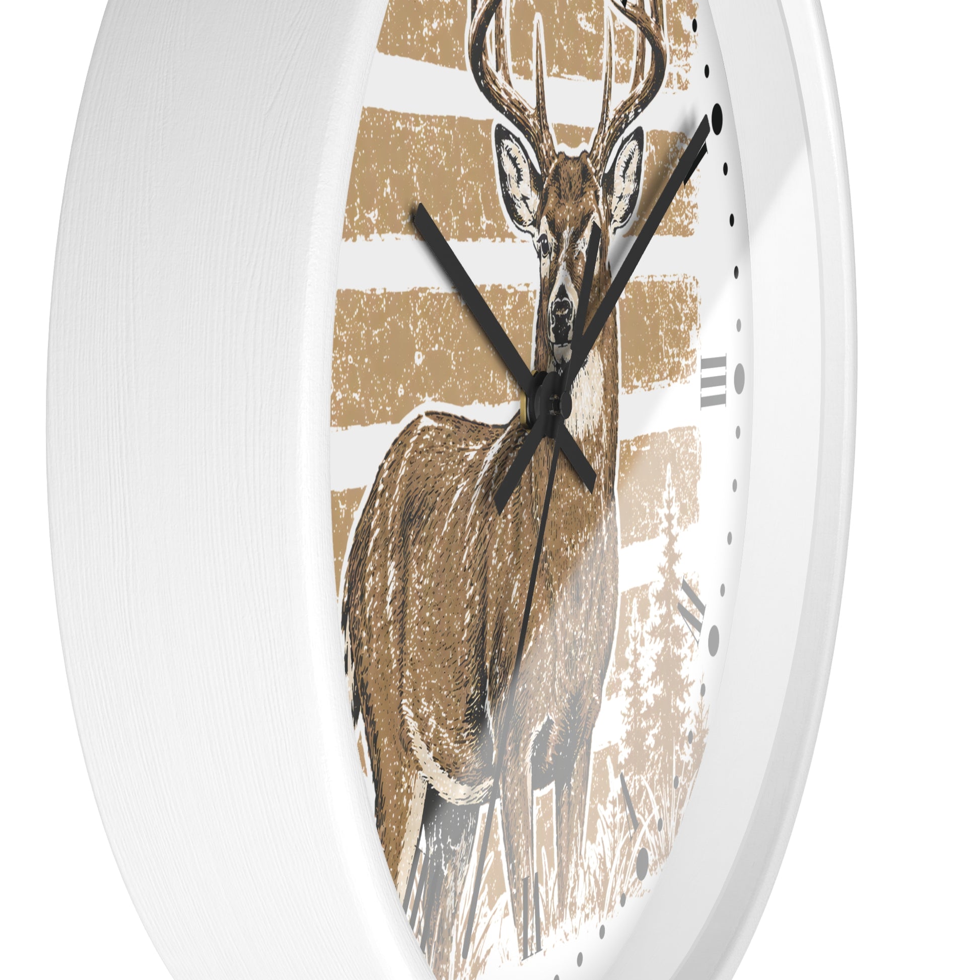 Round wall clock with a white frame and a printed deer illustration on the face. The design features a brown deer over tan and white horizontal stripes, with black clock hands and black hour markers.