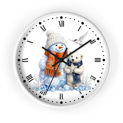 A round white wall clock with black Roman and dotted hour markers, featuring a winter illustration of a snowman in a beige hat and orange scarf, a polar bear in a blue scarf, and a small bird, shown on a white background.