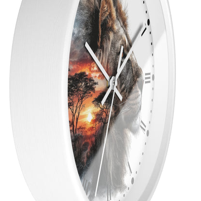 A white round wall clock with a split design: one half shows a close-up lion face, and the other half shows an African savanna sunset scene. The clock has white hands, black Roman numerals, and a glossy finish, shown against a plain white background.