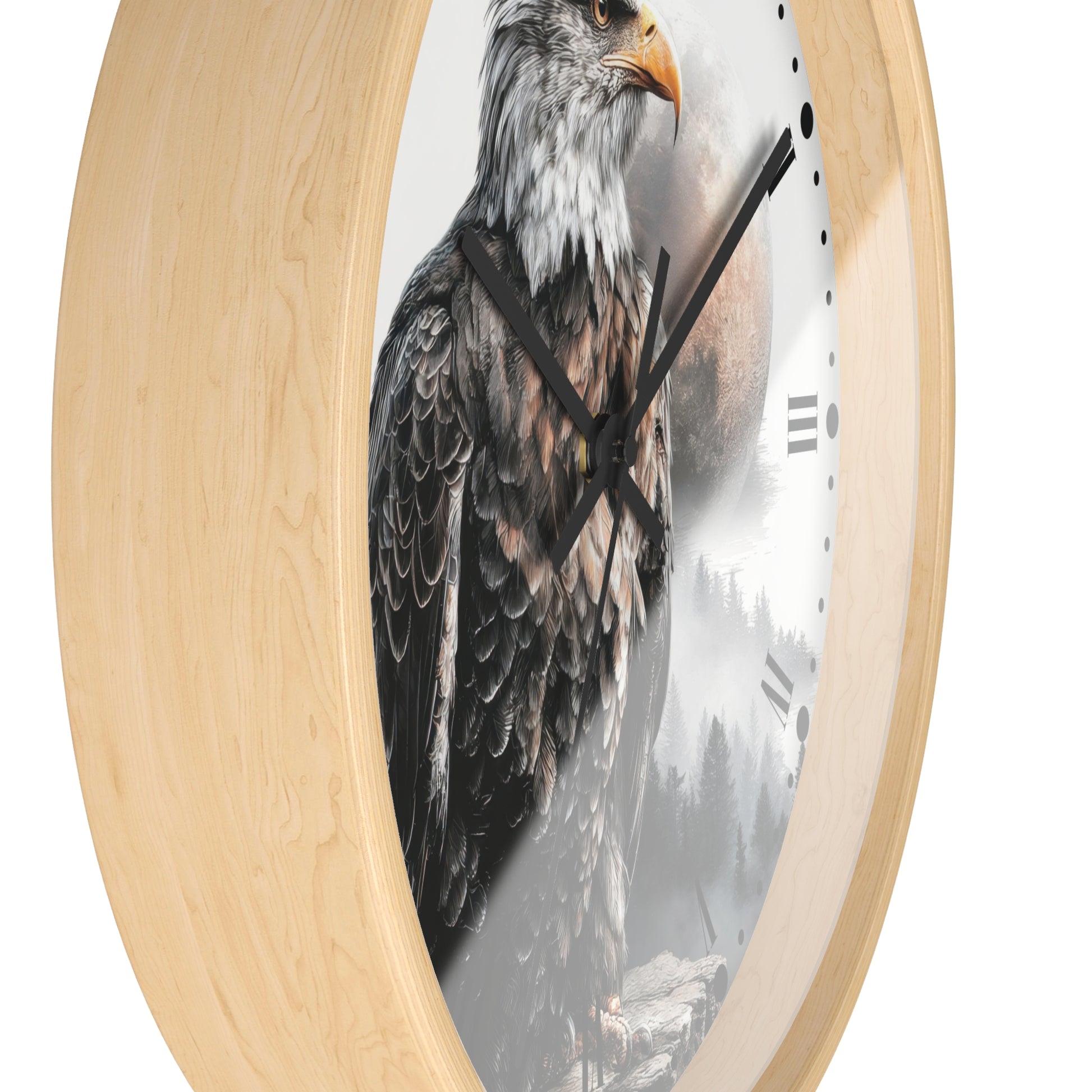 Round wall clock with a light natural wood frame and a printed design of a bald eagle over a misty forest scene on the clock face.