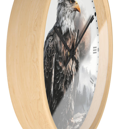 Round wall clock with a light natural wood frame and a printed design of a bald eagle over a misty forest scene on the clock face.