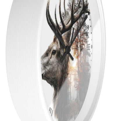 An oval wall clock with a white frame and hands, featuring a printed design of a deer head in profile over a misty forest scene with autumn trees.