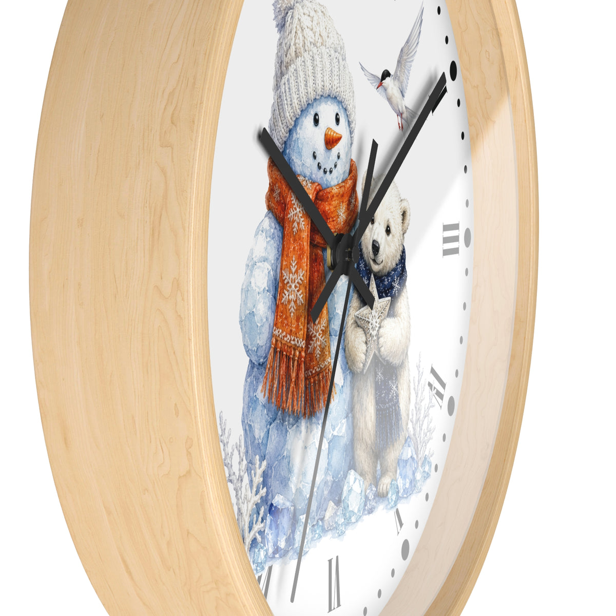 Round wall clock with a light natural wood frame and a white face featuring a winter illustration of a snowman in a knit hat and scarf, a polar bear, and a small bird.