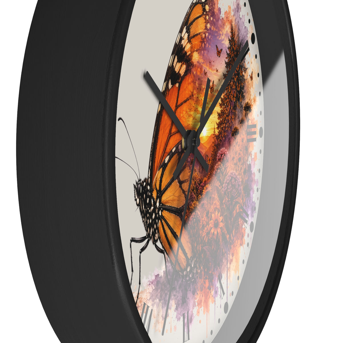 A close-up of a round wall clock with a black frame and a printed butterfly artwork on the face. The design shows a large orange-and-black butterfly over a purple, pink, and orange watercolor-style background, with black clock hands and no visible numbers.