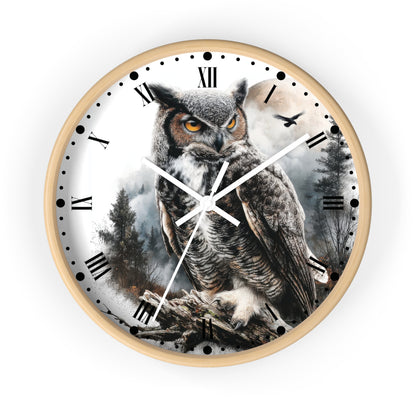 Round wall clock with a light wood frame and a printed owl scene on the face. The dial shows black Roman numerals, white clock hands, and a forest-and-owl artwork in gray, brown, black, and white tones.