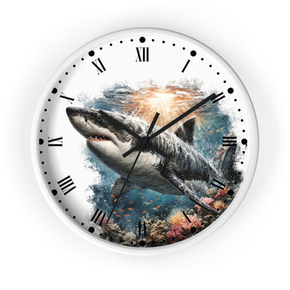 A round wall clock with a white frame and a printed design of a great white shark swimming over an underwater coral reef, with Roman numerals on a white background.