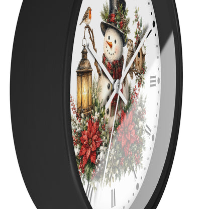 A round wall clock with a black frame and a white face featuring a festive winter illustration of a snowman, lantern, bird, owl, flowers, and poinsettias.