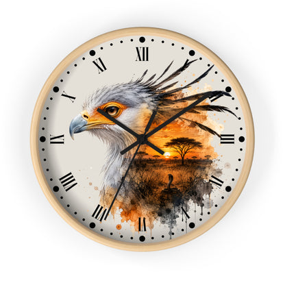A round wall clock with a light wood frame and a printed design featuring a bird of prey over an African savanna sunset scene. The clock face is off-white with black Roman numerals and hands, set against a clean white background.
