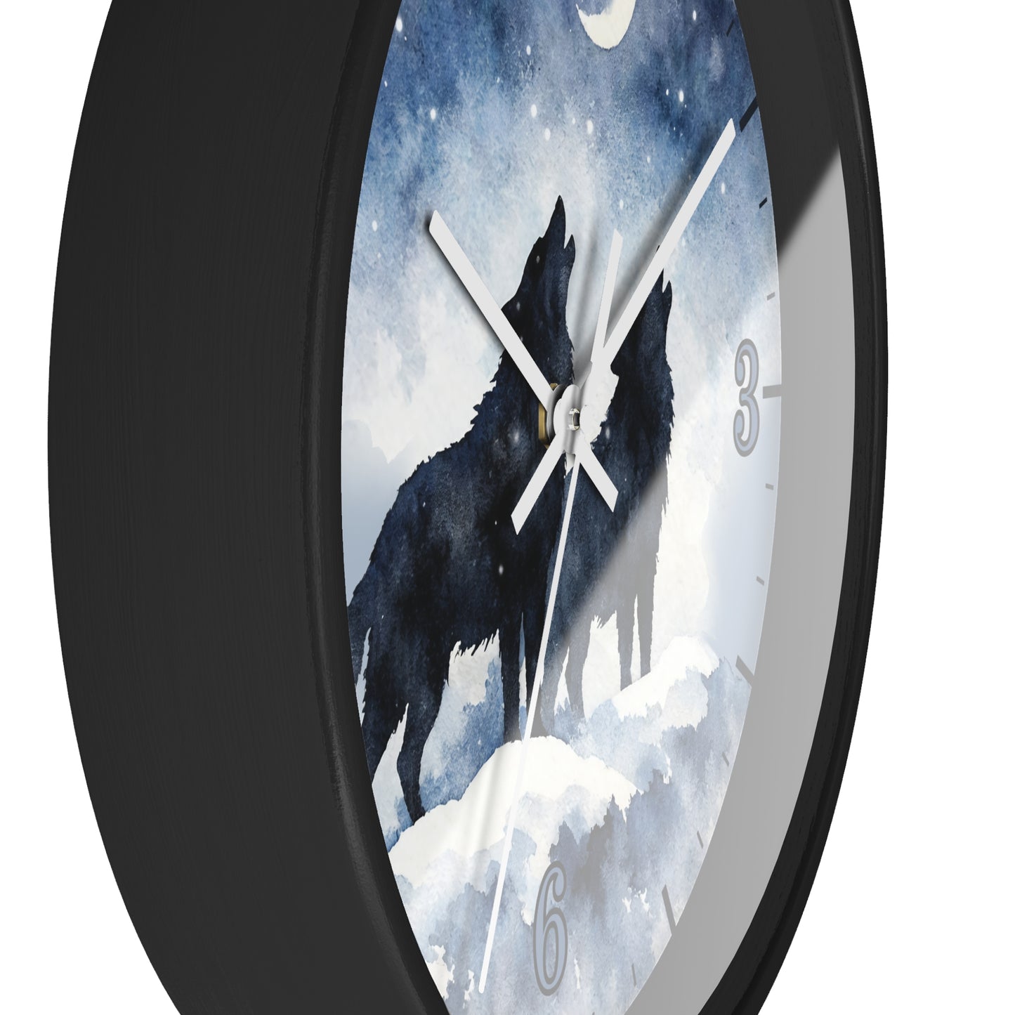 A round wall clock with a black frame and a printed dial showing two black wolves howling at a moonlit snowy scene. The clock is photographed against a plain white background.
