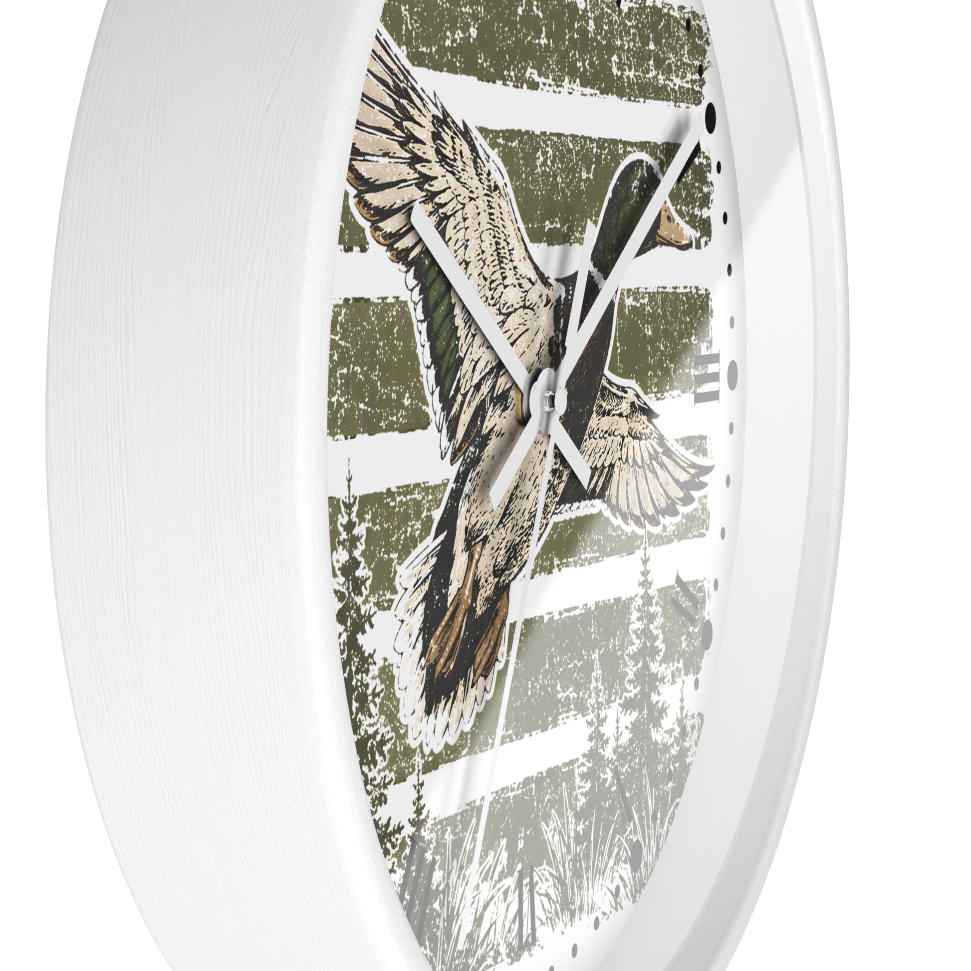 A white oval wall clock featuring a rustic printed design of a flying mallard duck over a forest scene in muted green, brown, and beige tones.