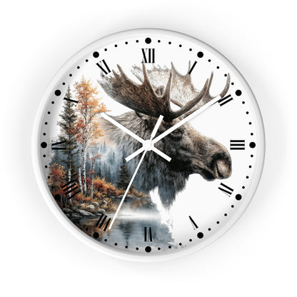 A round wall clock with a white frame and face, featuring a realistic moose head illustration over a forest and lake scene, with black Roman numerals and clock hands on a white background.