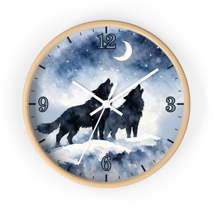 Round wall clock with a light wood frame and a watercolor-style night sky face showing two black howling wolves under a crescent moon and stars. The clock has blue-toned numerals and white hands on a white background.