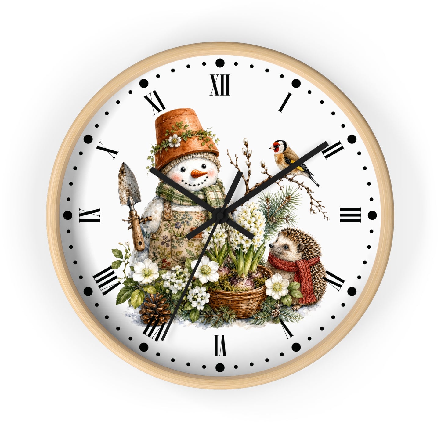 A round wall clock with a light natural wood frame and a white face featuring a detailed winter garden illustration. The design includes a snowman wearing a terracotta pot hat, a small bird, a hedgehog in a red scarf, white flowers, pinecones, and a garden spade, with black Roman numerals and hands.