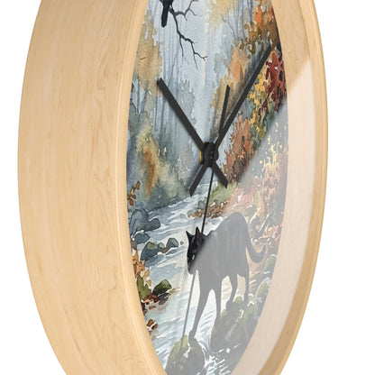 Round wall clock with a light natural wood frame and a printed scenic dial showing a forest stream, autumn foliage, and a black cat silhouette.
