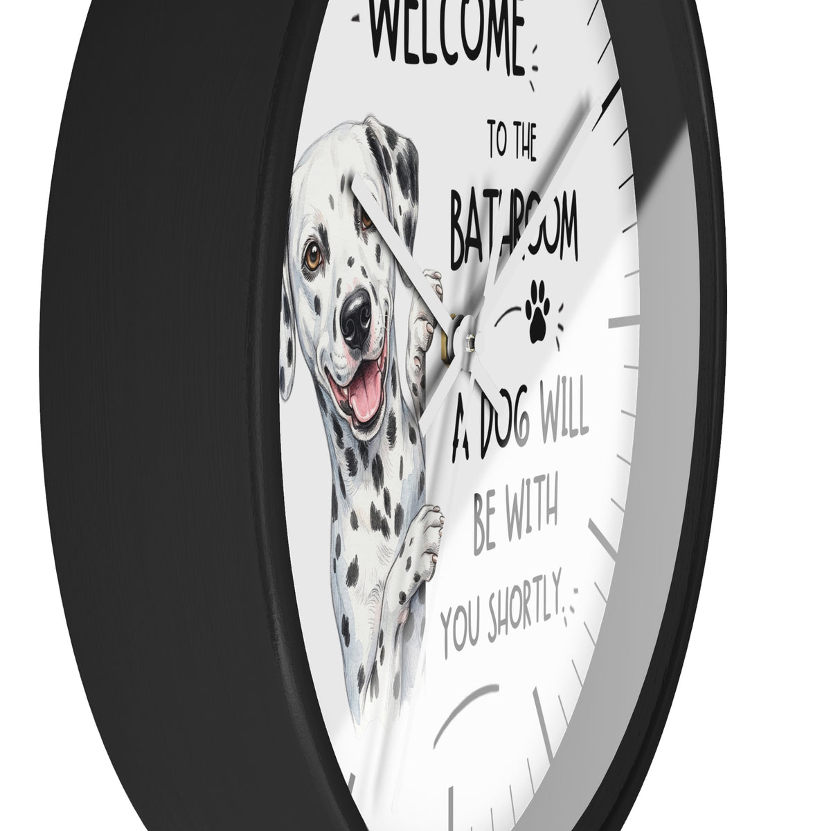 A round wall clock with a black frame and a white face featuring a Dalmatian illustration and the text 'WELCOME TO THE BATHROOM A DOG WILL BE WITH YOU SHORTLY'.