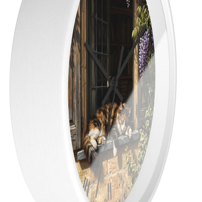 Round white wall clock with a printed illustration of a cat resting by a window and purple wisteria flowers, shown against a plain white background.