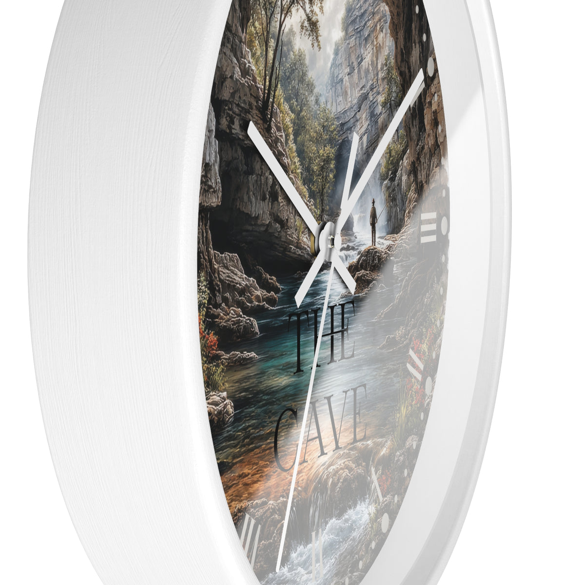 Round wall clock with a white frame and a scenic print of a cave interior, river, and waterfall. The words 'THE CAVE' are printed on the dial, and the clock has white hands against a white background.